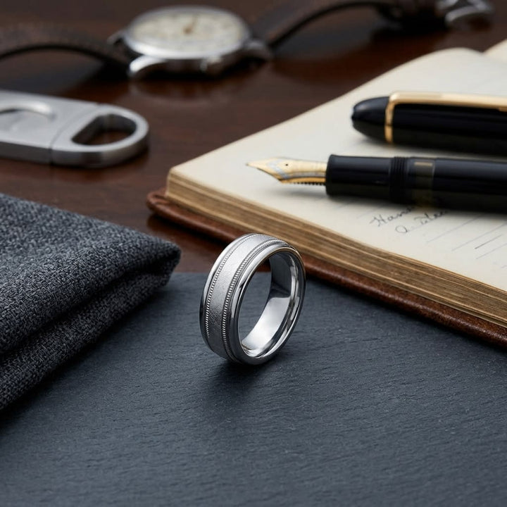 7mm Round Edge Swirl Finish Carved Wedding Band in Platinum, on walnut surface with pocket square
