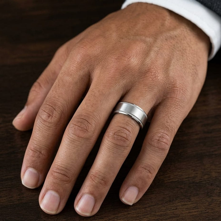 8mm Satin Finish Carved Wedding Band in Platinum, worn on hand, masculine close-up