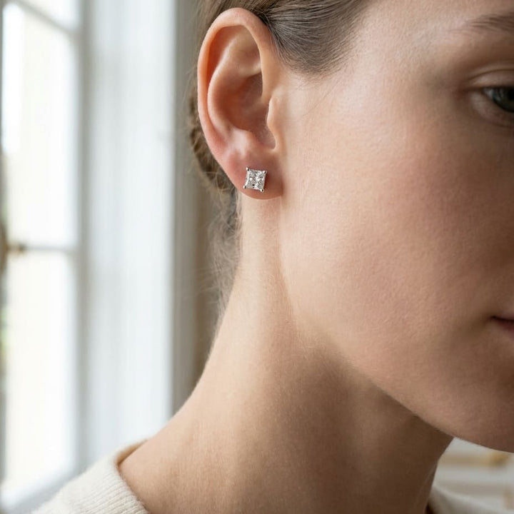 Platinum 4-prong Princess Diamond Stud Earrings (0.25 Ct. T.w., Vs1-vs2 Clarity, F-g Color), worn close-up portrait