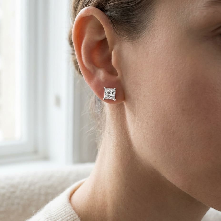 Natural Diamond Princess Cut Four Prong Stud Earrings in Platinum, 1.1 ct. t.w., worn close-up portrait