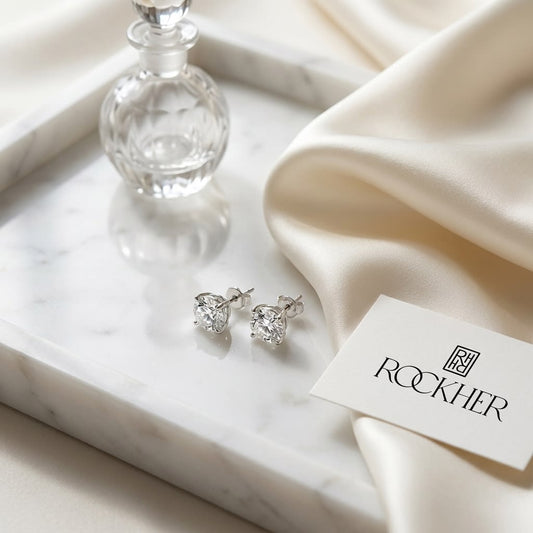 Platinum 4-prong Round Brilliant Diamond Stud Earrings (0.75 Ct. T.w., Si1-si2 Clarity, J-k Color), on marble vanity tray with silk