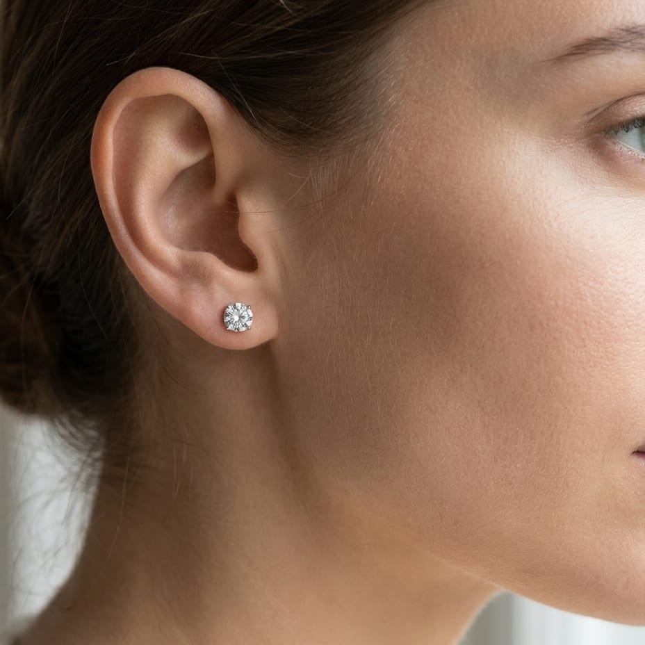 Platinum 4-prong Round Brilliant Diamond Stud Earrings (2.09 Ct. T.w., Vs1-vs2 Clarity, H-i Color), worn close-up portrait