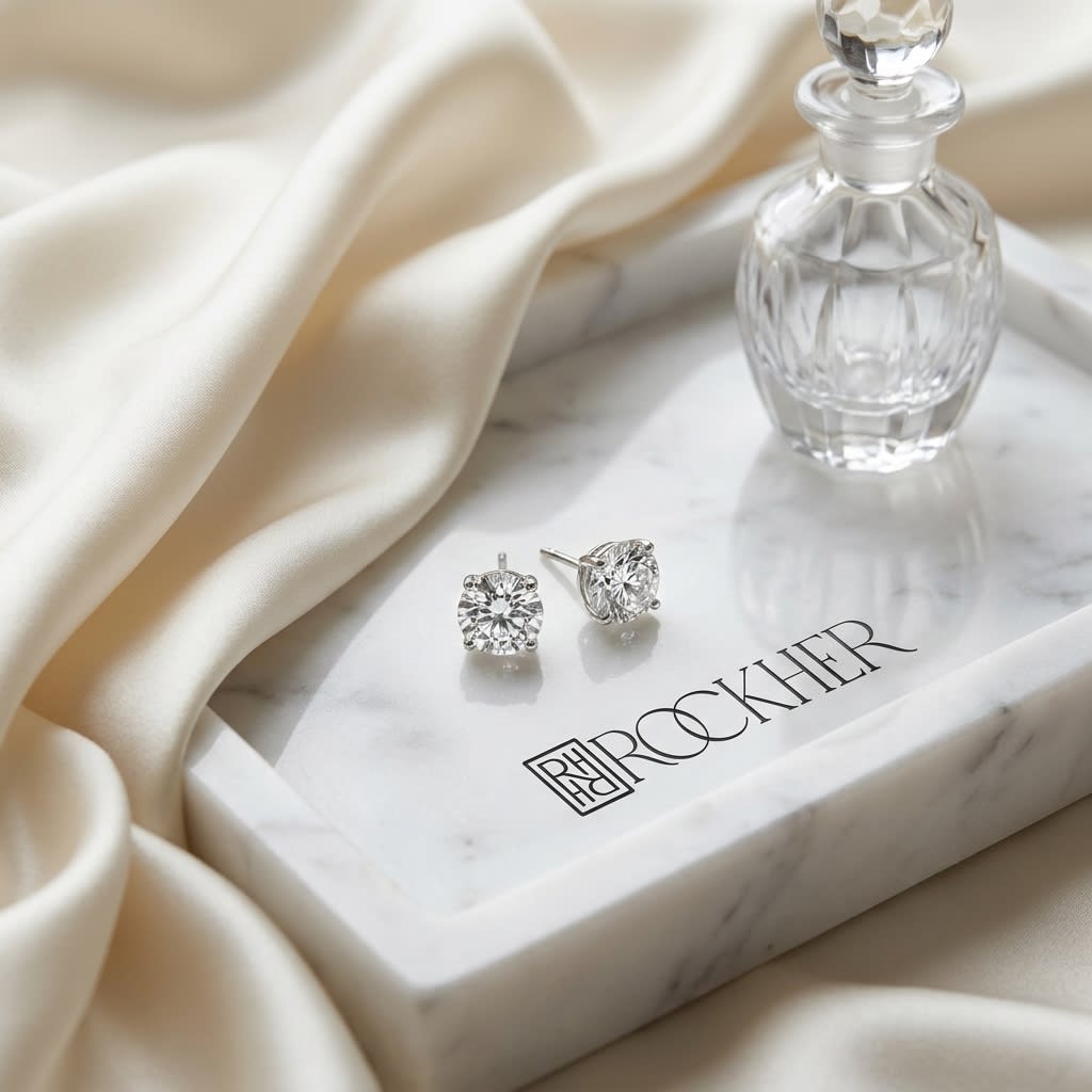 Platinum Bezel Set Round Brilliant Diamond Stud Earrings (0.22 Ct. T.w., Vs1-vs2 Clarity, F-g Color), on marble vanity tray with silk