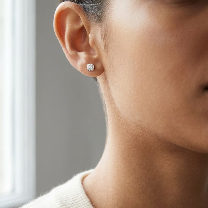 Platinum Bezel Set Round Brilliant Diamond Stud Earrings (0.22 Ct. T.w., Vs1-vs2 Clarity, F-g Color), worn close-up portrait