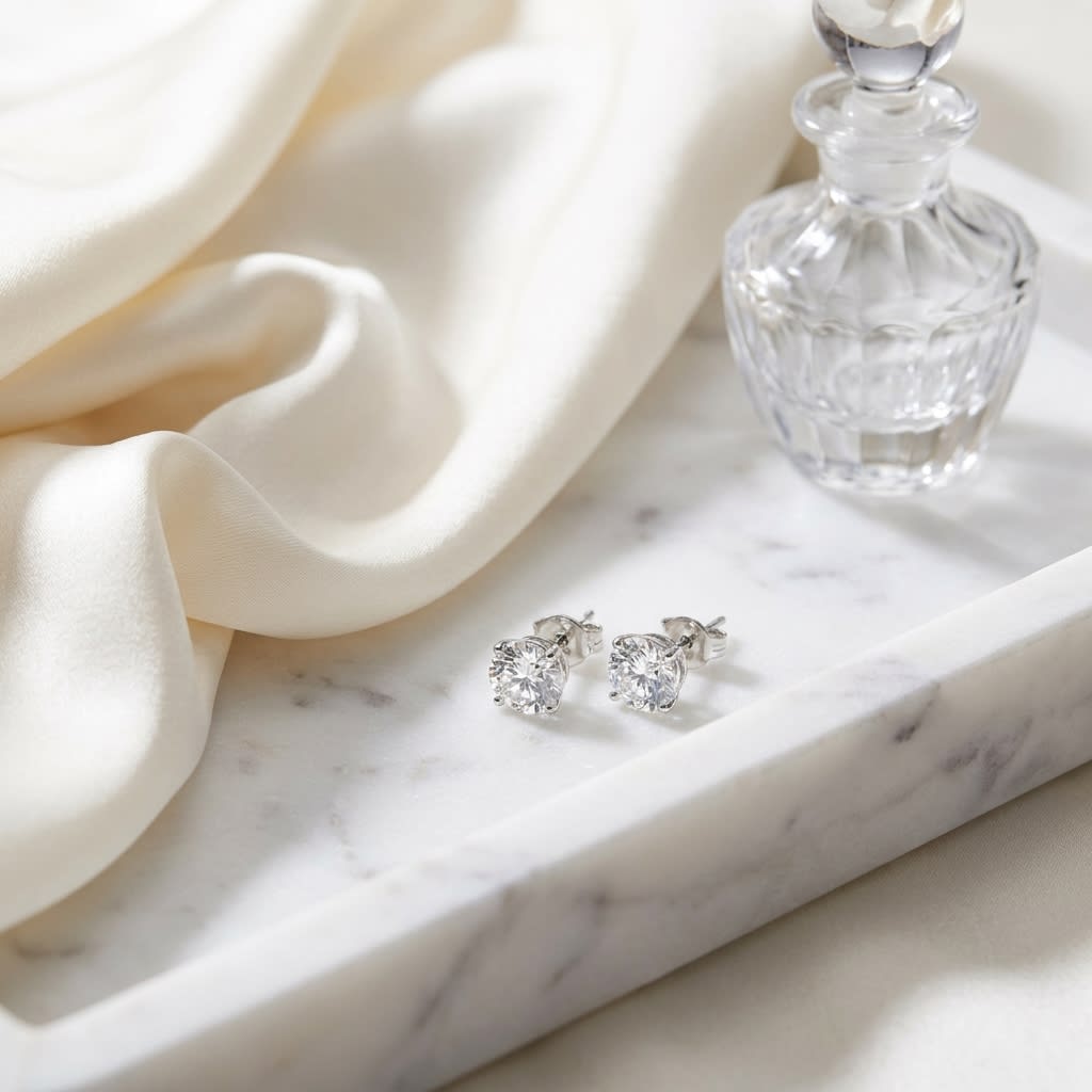Platinum Bezel Set Round Brilliant Diamond Stud Earrings (0.22 Ct. T.w., Si1-si2 Clarity, H-i Color), on marble vanity tray with silk