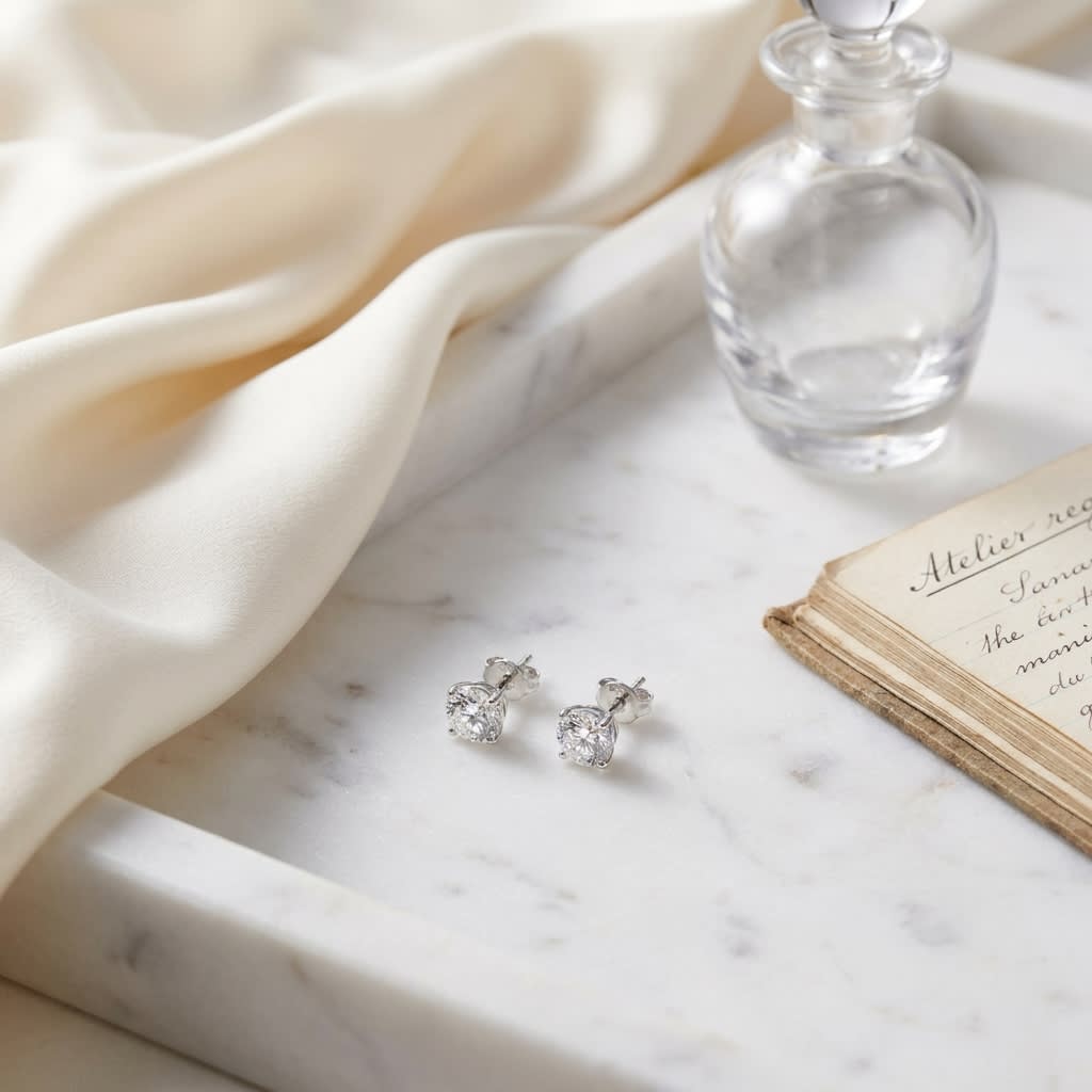 Platinum Bezel Set Round Brilliant Diamond Stud Earrings (0.22 Ct. T.w., Si1-si2 Clarity, J-k Color), on marble vanity tray with silk