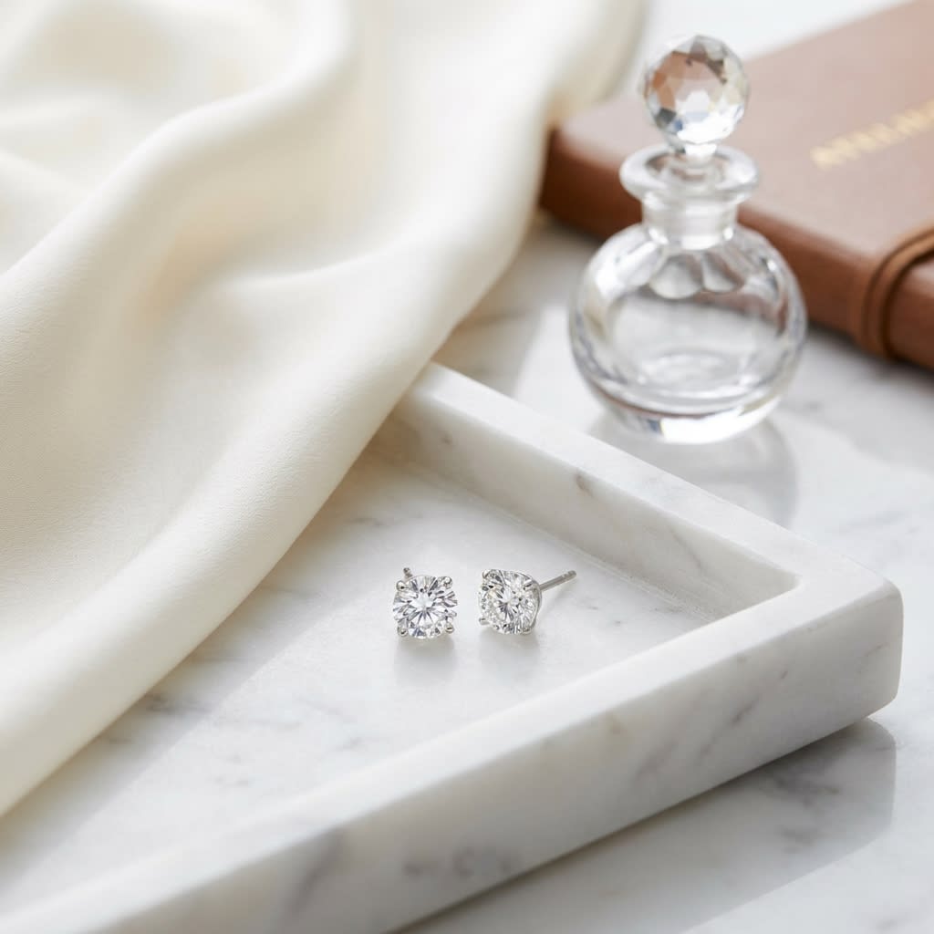 Platinum Bezel Set Round Brilliant Diamond Stud Earrings (0.32 Ct. T.w., Vs1-vs2 Clarity, H-i Color), on marble vanity tray with silk