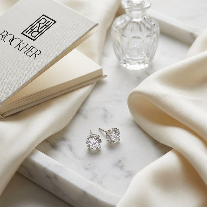 Platinum Bezel Set Round Brilliant Diamond Stud Earrings (0.32 Ct. T.w., Si1-si2 Clarity, J-k Color), on marble vanity tray with silk