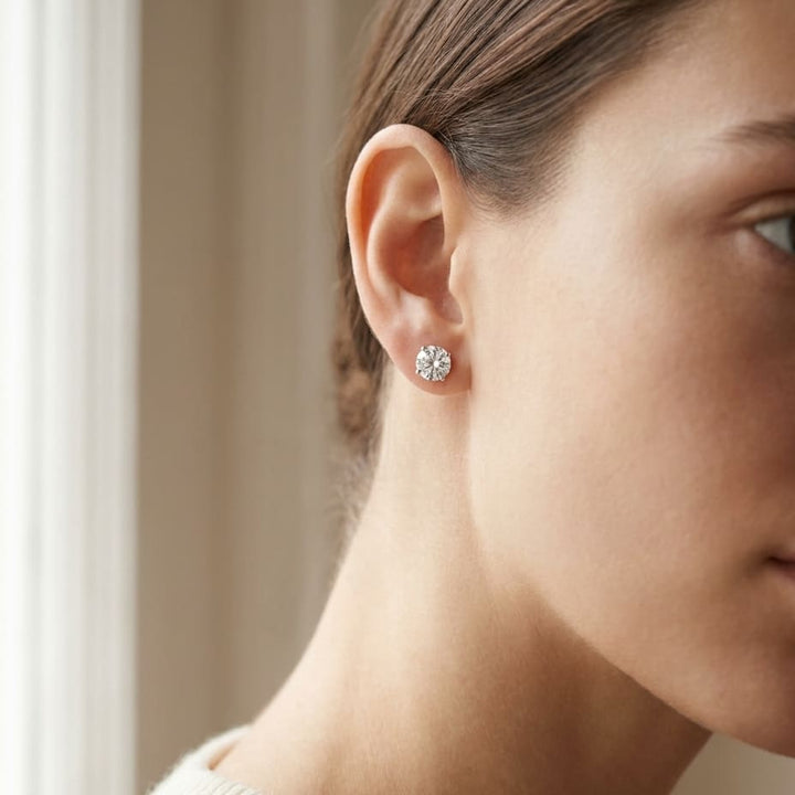 Platinum Bezel Set Round Brilliant Diamond Stud Earrings (0.5 Ct. T.w., Vs1-vs2 Clarity, H-i Color), worn close-up portrait