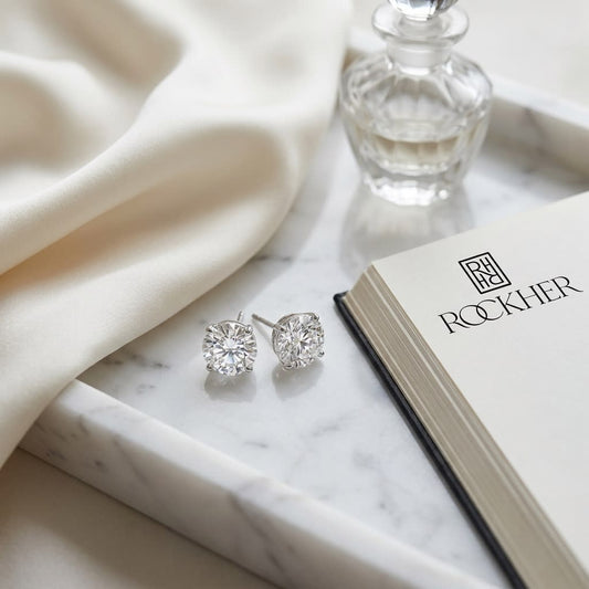 Platinum Bezel Set Round Brilliant Diamond Stud Earrings (0.52 Ct. T.w., Si1-si2 Clarity, J-k Color), on marble vanity tray with silk