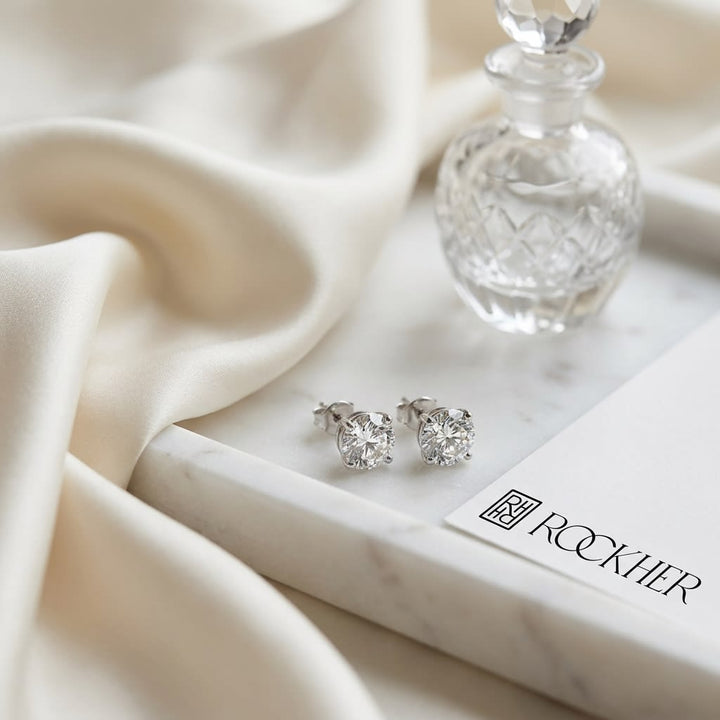 Platinum Bezel Set Round Brilliant Diamond Stud Earrings (0.75 Ct. T.w., Vs1-vs2 Clarity, H-i Color), on marble vanity tray with silk