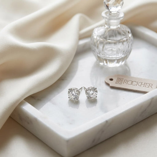 Platinum Bezel Set Round Brilliant Diamond Stud Earrings (1.06 Ct. T.w., Vs1-vs2 Clarity, F-g Color), on marble vanity tray with silk