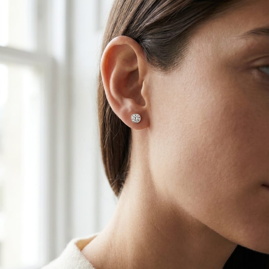 Platinum Bezel Set Round Brilliant Diamond Stud Earrings (1 Ct. T.w., Si1-si2 Clarity, H-i Color), worn close-up portrait