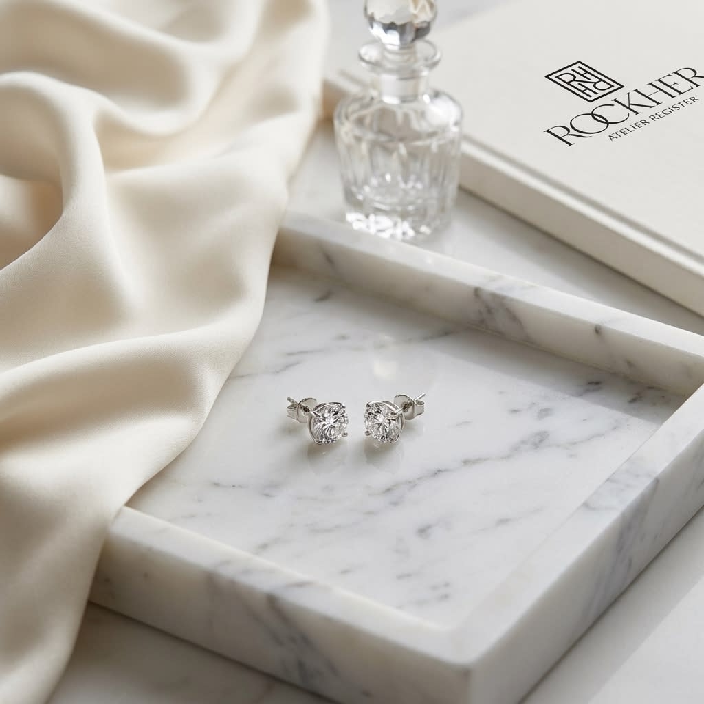 Natural Diamond Round Brilliant Bezel Stud Earrings in Platinum, 1 ct. t.w., on marble vanity tray with silk