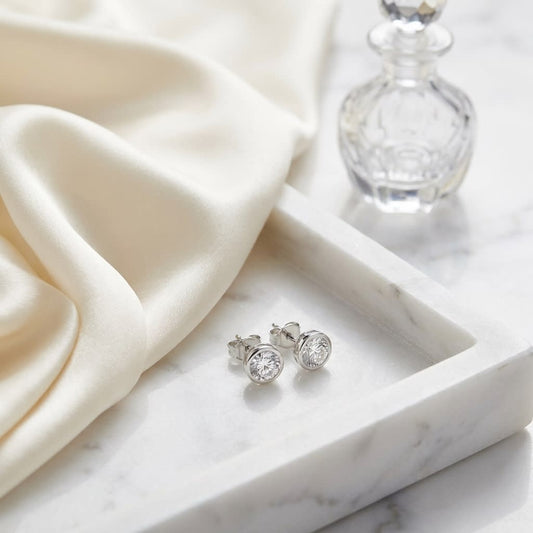 Platinum Bezel Set Round Brilliant Diamond Stud Earrings (1.47 Ct. T.w., Si1-si2 Clarity, H-i Color), on marble vanity tray with silk