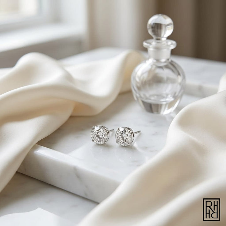 Platinum Bezel Set Round Brilliant Diamond Stud Earrings (1.48 Ct. T.w., Vs1-vs2 Clarity, H-i Color), on marble vanity tray with silk