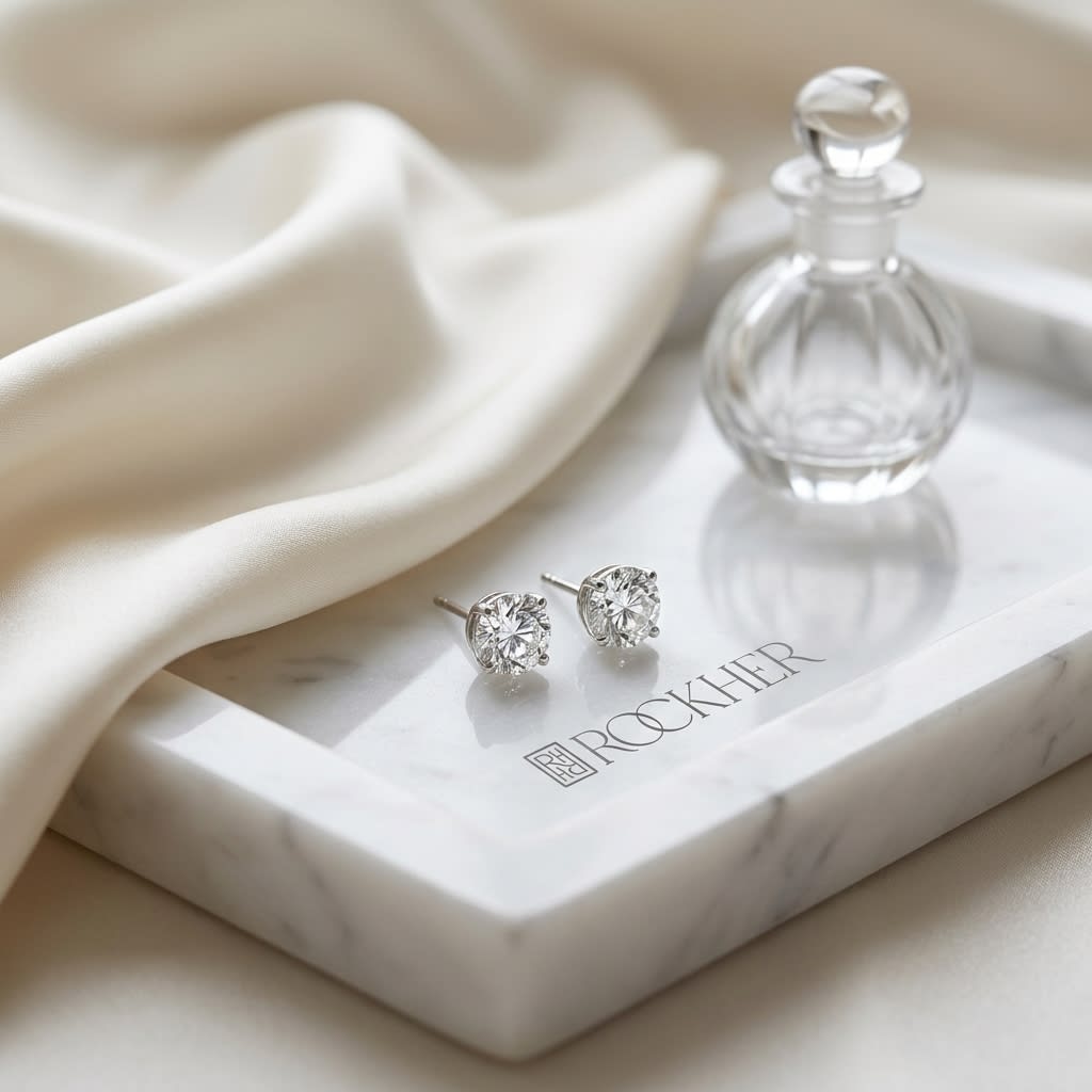 Platinum Bezel Set Round Brilliant Diamond Stud Earrings (2.09 Ct. T.w., Si1-si2 Clarity, H-i Color), on marble vanity tray with silk