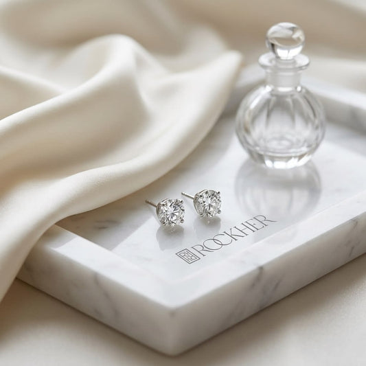 Platinum Bezel Set Round Brilliant Diamond Stud Earrings (2.09 Ct. T.w., Si1-si2 Clarity, H-i Color), on marble vanity tray with silk