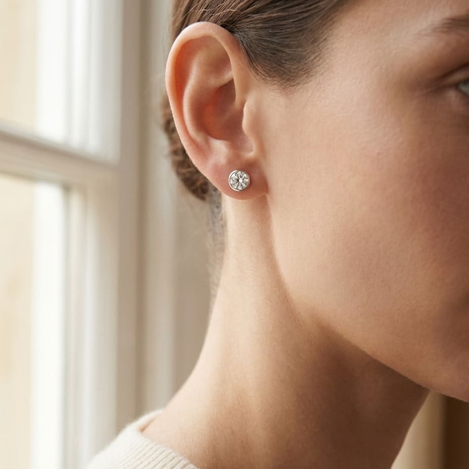 Platinum Bezel Set Round Brilliant Diamond Stud Earrings (2.09 Ct. T.w., Si1-si2 Clarity, H-i Color), worn close-up portrait