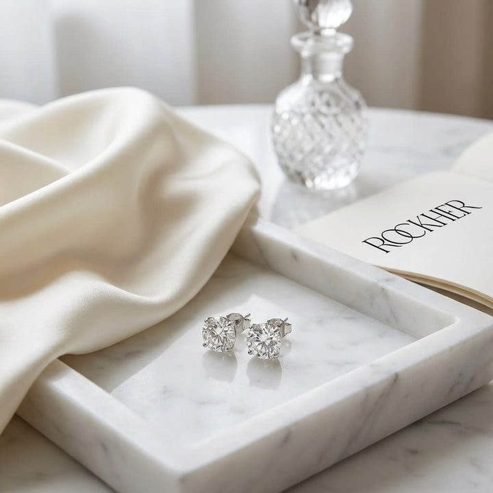 Platinum Bezel Set Round Brilliant Diamond Stud Earrings (2.09 Ct. T.w., Vs1-vs2 Clarity, H-i Color), on marble vanity tray with silk