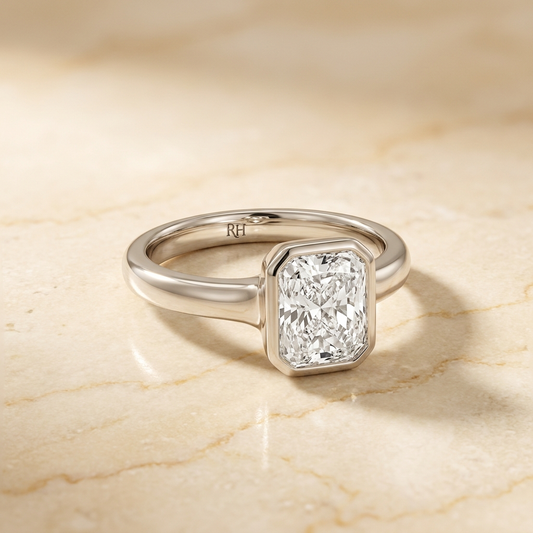 The Agnes Select bezel solitaire radiant engagement ring in 18k white gold — alt-angle hero — RockHer