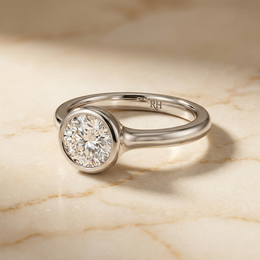 The Agnes Select bezel solitaire round brilliant engagement ring in platinum — alt-angle hero — RockHer
