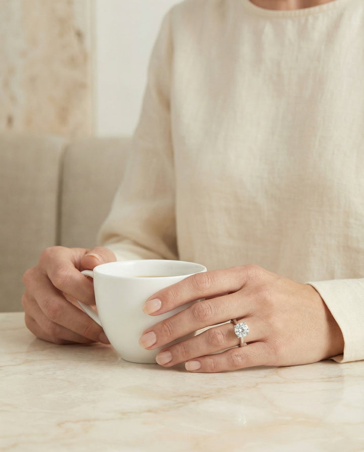 Secret Halo Adorned Prong Solitaire Cushion, in Platinum – lifestyle shot | RockHer