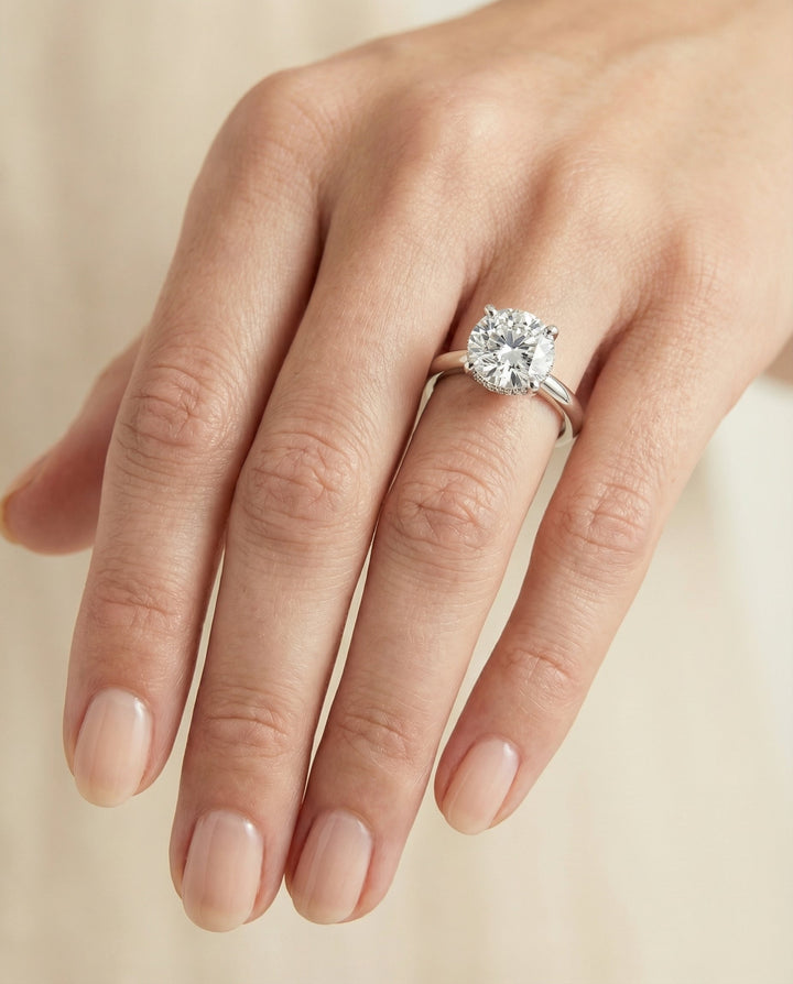 Secret Halo Adorned Prong Solitaire Cushion, in Platinum – lifestyle shot | RockHer