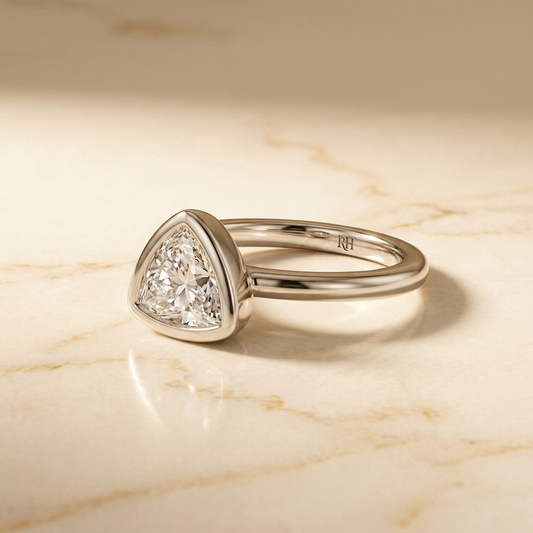 The Agnes Select bezel solitaire trillion engagement ring in platinum — alt-angle hero — RockHer