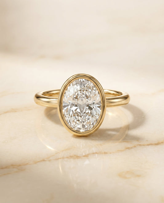 The Agnes Bezel Solitaire Engagement Ring Setting for Oval Diamonds in 18K Yellow Gold | RockHer