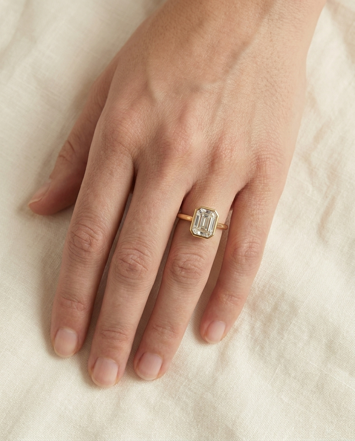 The Agnes Select bezel solitaire asscher engagement ring in 18k yellow gold — top down hand — RockHer