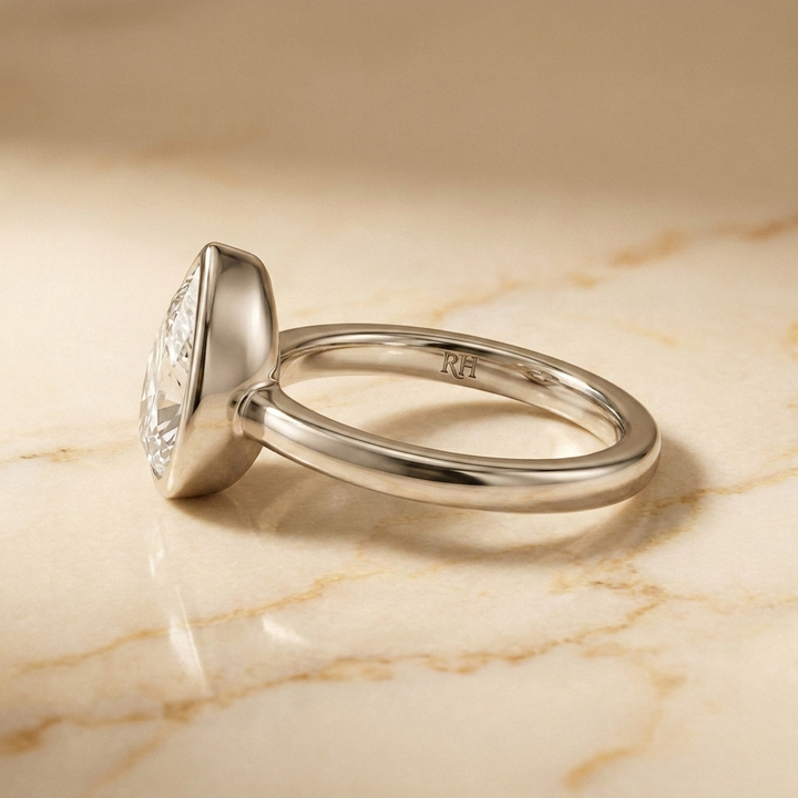 The Agnes Select bezel solitaire briolette engagement ring in 18k white gold — side profile — RockHer