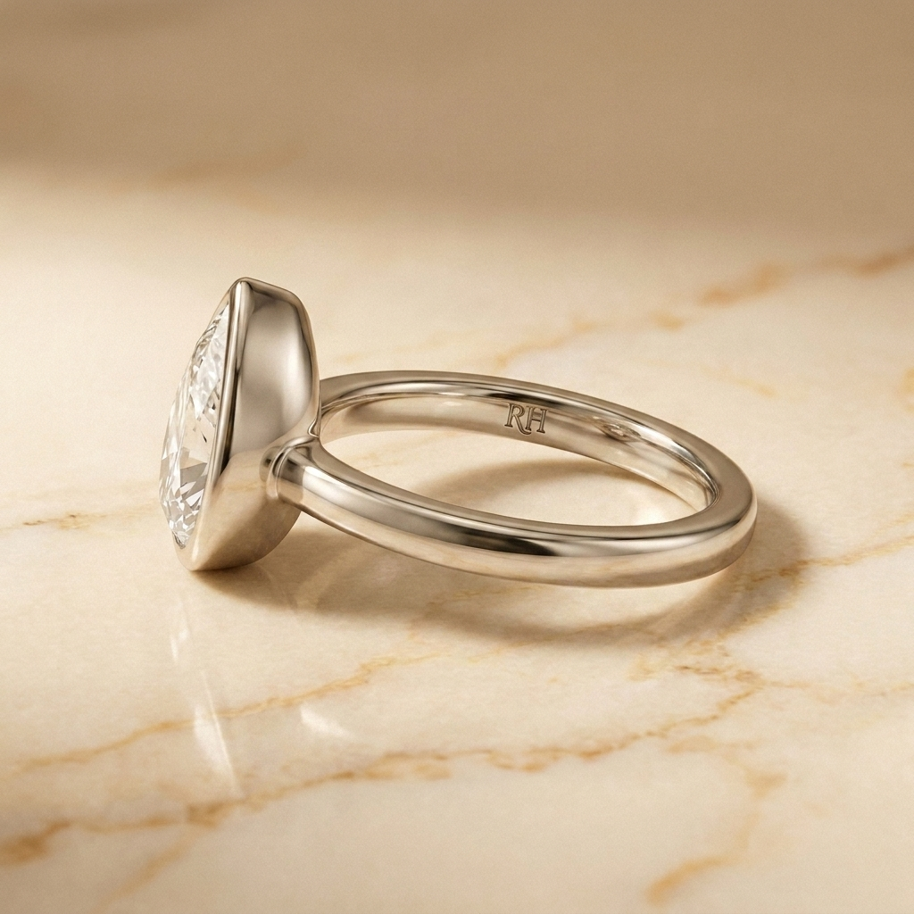 The Agnes Select bezel solitaire briolette engagement ring in platinum — side profile — RockHer