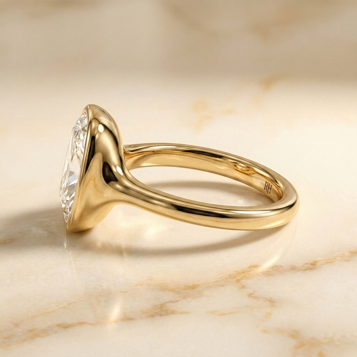 The Agnes Select bezel solitaire cushion engagement ring in 18k yellow gold — side profile — RockHer