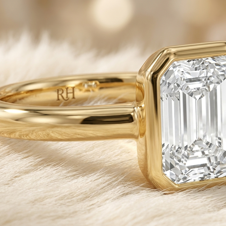 The Agnes Select bezel solitaire emerald cut engagement ring in 18k yellow gold — construction detail — RockHer