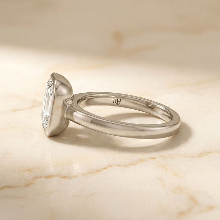 The Agnes Select bezel solitaire emerald cut engagement ring in 18k white gold — side profile — RockHer