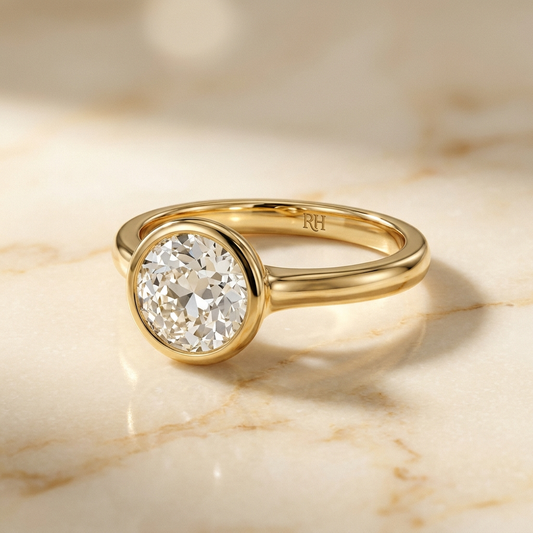 The Agnes Select bezel solitaire old european cut engagement ring in 18k yellow gold — alt-angle hero — RockHer