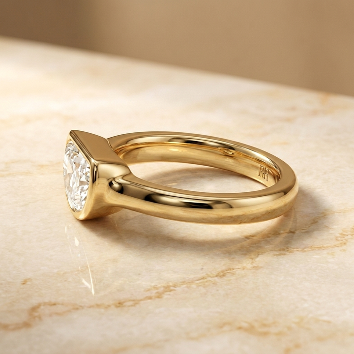 The Agnes Select bezel solitaire half cut engagement ring in 18k yellow gold — side profile — RockHer