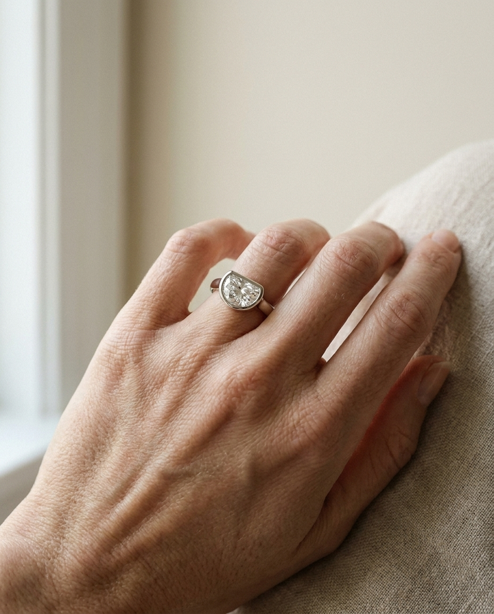 The Agnes Select bezel solitaire half cut engagement ring in 18k white gold — on hand — RockHer
