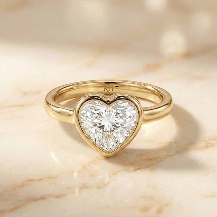 The Agnes Select bezel solitaire heart engagement ring in 18k yellow gold — front view — RockHer