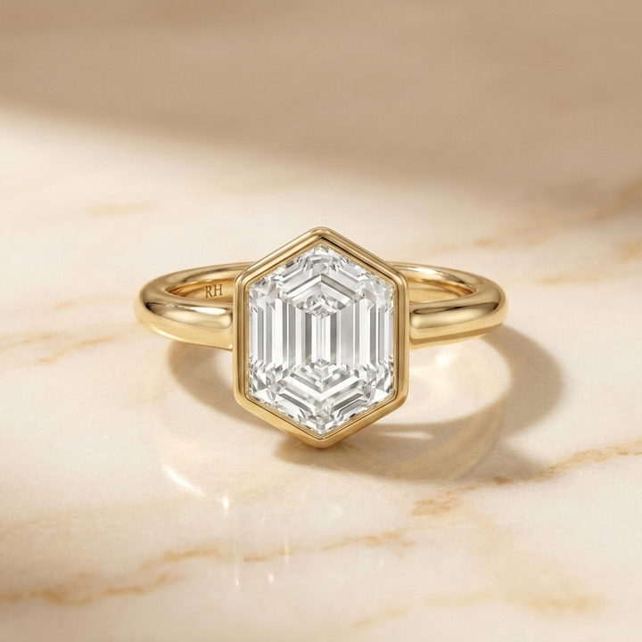 The Agnes Select bezel solitaire hexagonal engagement ring in 18k yellow gold — front view — RockHer