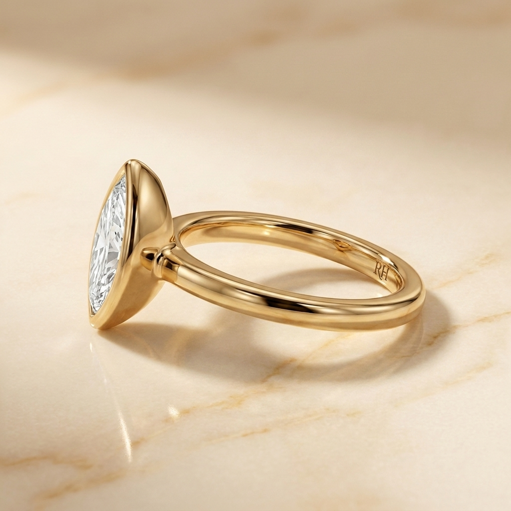The Agnes Select bezel solitaire marquise engagement ring in 18k yellow gold — side profile — RockHer