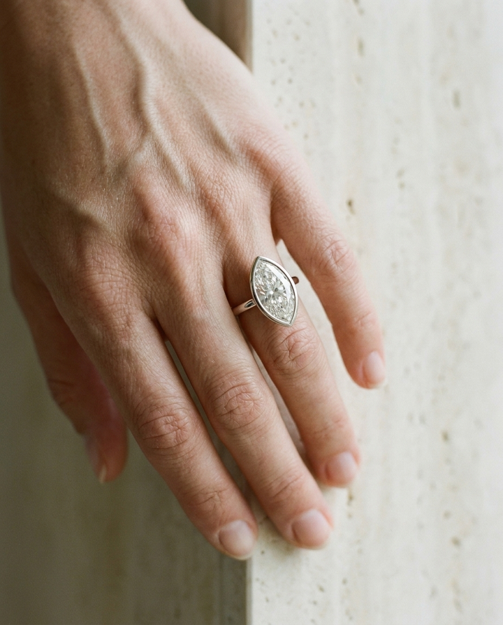 The Agnes Select bezel solitaire marquise engagement ring in 18k white gold — on hand — RockHer