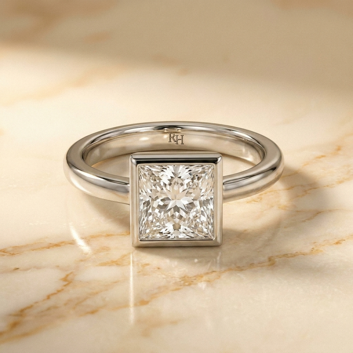 The Agnes Select bezel solitaire princess engagement ring in 18k white gold — front view — RockHer