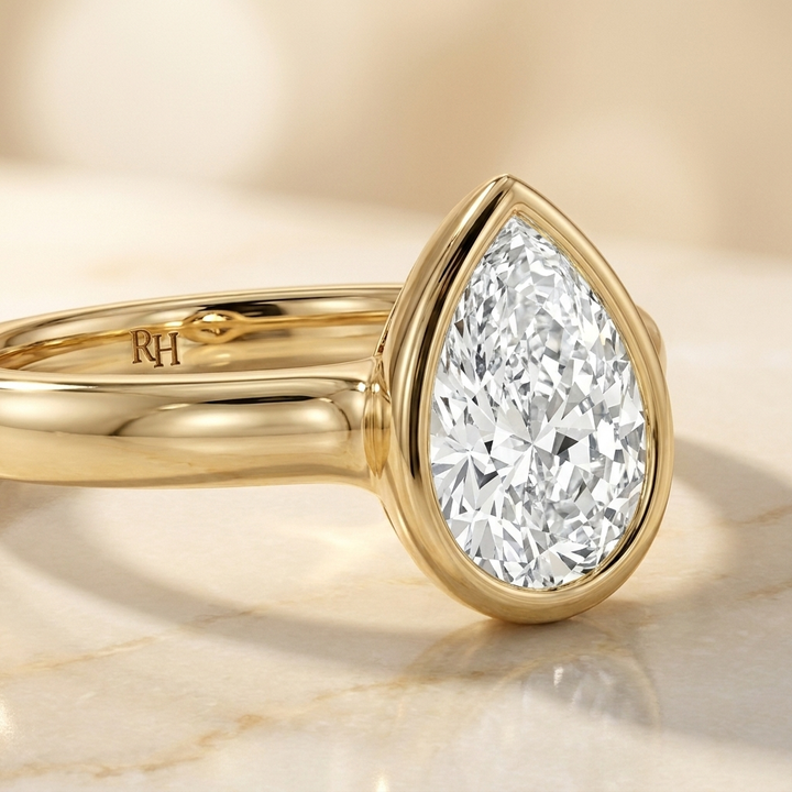 The Agnes Select bezel solitaire pear engagement ring in 18k yellow gold — construction detail — RockHer