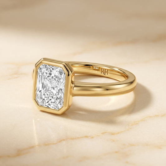 The Agnes Select bezel solitaire radiant engagement ring in 18k yellow gold — alt-angle hero — RockHer