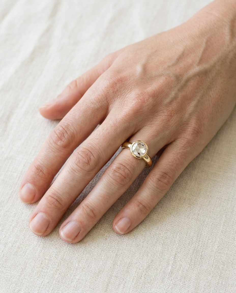 The Agnes Select bezel solitaire rose cut engagement ring in 18k yellow gold — top down hand — RockHer