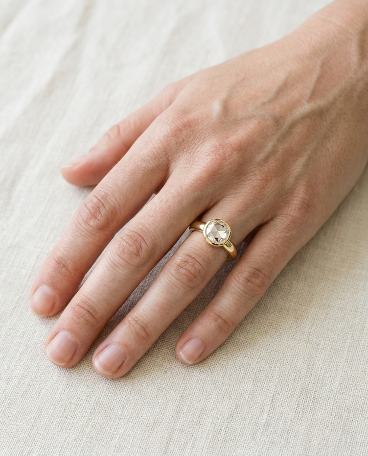 The Agnes Select bezel solitaire rose cut engagement ring in 18k yellow gold — top down hand — RockHer
