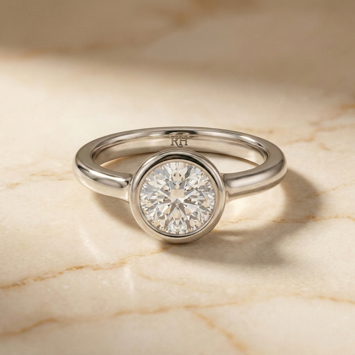 The Agnes Select bezel solitaire round brilliant engagement ring in 18k white gold — front view — RockHer