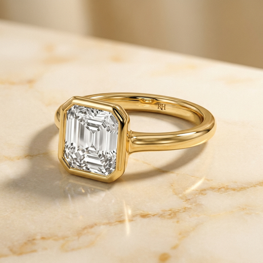 The Agnes Select bezel solitaire square emerald engagement ring in 18k yellow gold — alt-angle hero — RockHer